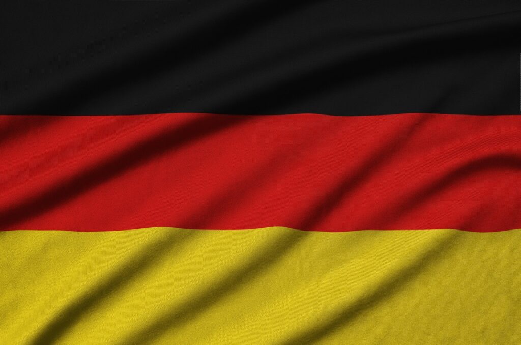 Germany flag is depicted on a sports cloth fabric with many folds. Sport team waving banner